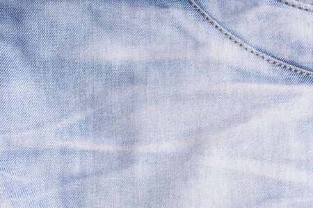 Blue denim. Cotton fabric, jeans. Creative vintage background. Pocket and zipper. The line is of...
