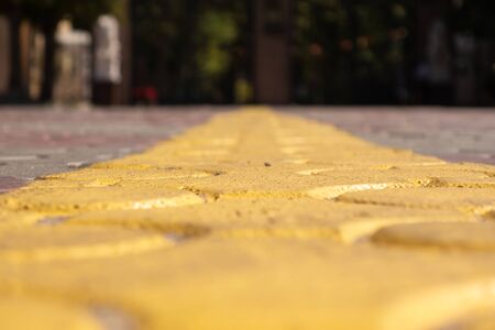 Yellow line marking on the paving stones. Solid line. Selective focusの写真素材