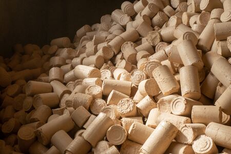 Pellets from pressed sawdust, solid fuel, non-waste technology. Handicraft production. Saving natural resourcesの写真素材