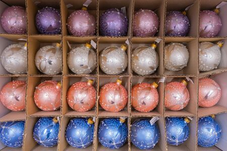 Christmas-tree decorations of different shapes and colors in packaging on a store shelf. 2019.04.12. Odessa. Ukraine.のeditorial素材