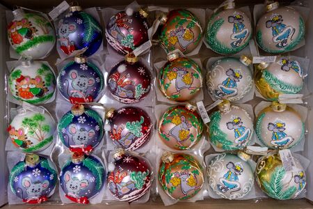 Christmas-tree decorations of different shapes and colors in packaging on a store shelf. 2019.04.12. Odessa. Ukraine.のeditorial素材