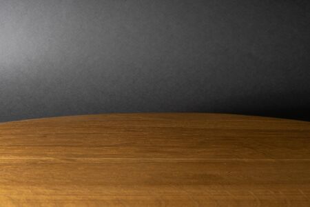 Wooden table and dark gray background. A place to place various itemsの写真素材