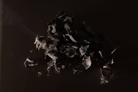 Burning bill of 200 Ukrainian hryvnia. On a dark background