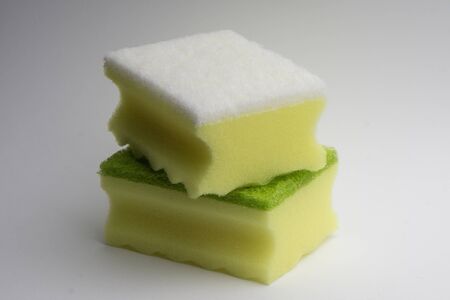 Two yellow-green foam sponge for washing dishes on a white background.の写真素材
