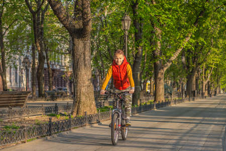 Boy 8 years old on a walk with a bicycle on a sunny spring day 2018.04.21. Odessa. Ukraine.のeditorial素材