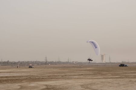 Paraglider on the lake over a sandy beachの写真素材