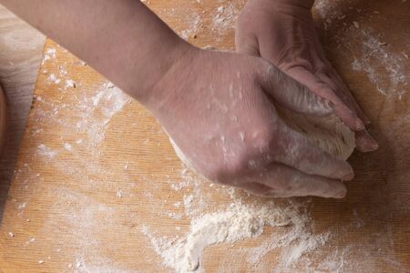 Female hands mixing dough in the home kitchen