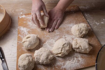 Female hands mixing dough in the home kitchen