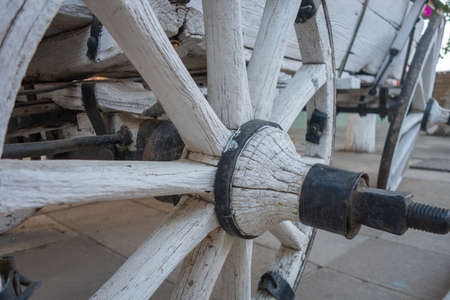 An old white cart and a wheel close-upの写真素材