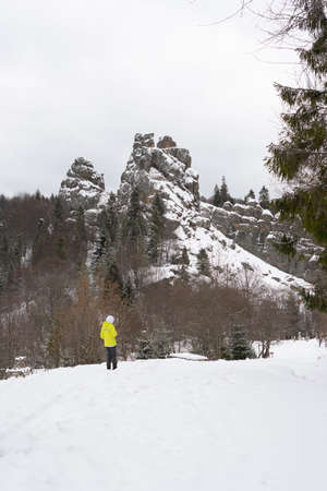 Boy 10 years old plays in the snow on the slope of the mountains. Selective focus. Tustan....