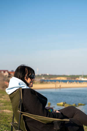 Brunette woman in a black coat with a white hoodの写真素材