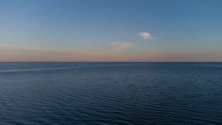 Calm sea at dawn. Blue sea and cloudsの写真素材