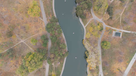 Walkways and footpaths in the city park in autumn. Leaf fall in the park. Autumn lake. Aerial viewの写真素材