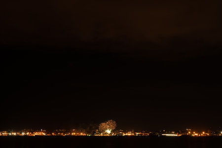 Fireworks and fireworks in the big city. view across the bayの写真素材