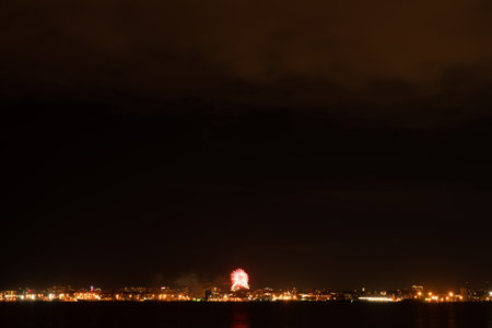 Fireworks and fireworks in the big city. view across the bayの写真素材