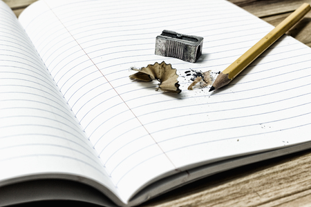 Top view of a wooden desk with office supplies placed.の写真素材
