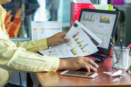Businessman sitting in front of a laptop computer.