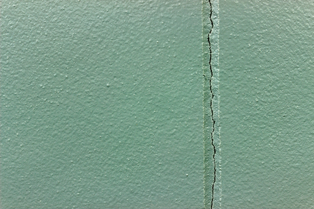 Cement wall backgrounds with cracks caused by non-standard construction design.の写真素材