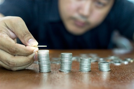 Man are stacking coins. the savings concept.の写真素材
