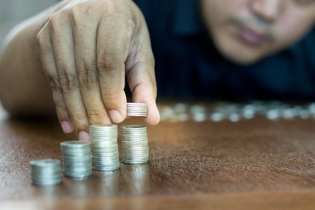 Man are stacking coins. the savings concept.の写真素材