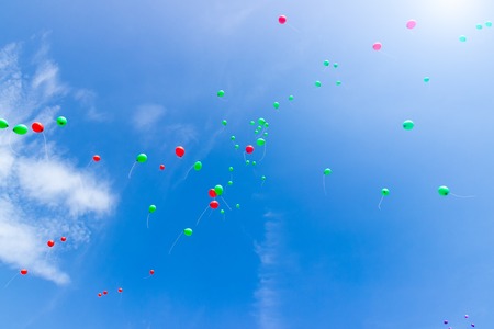 Colorful balloons floating in the skyの写真素材