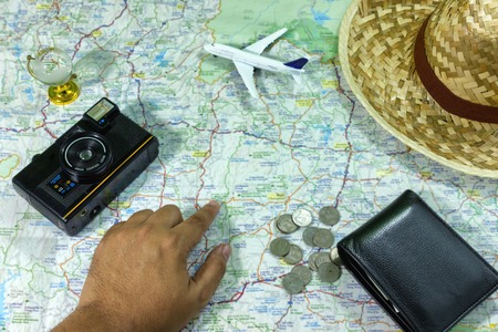 Travel Concepts Planning a trip with a camera. Model aircraft A small glass globe and a hat are placed on the map.の写真素材