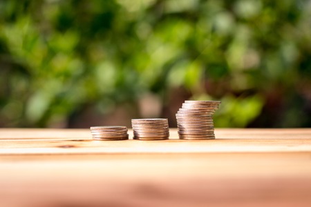 Coin placed on a wooden table with background blurryの写真素材