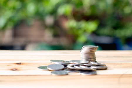 Coin placed on a wooden table with background blurryの写真素材