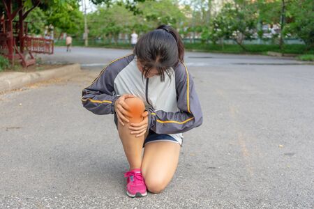 woman being Injuries to the leg muscles which are dangerous to the athlete from exercise that creates pain after outdoor sports without training that can cause both young and adults.の写真素材