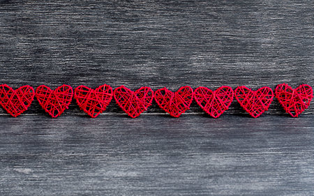 layout in the form of red hearts on a wooden background. Valentine's day concept