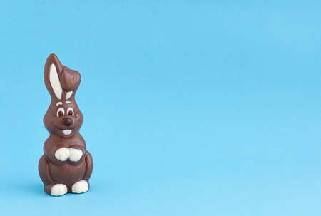 Easter chocolate brown bunny on a blue background. close-up. copy space.の写真素材