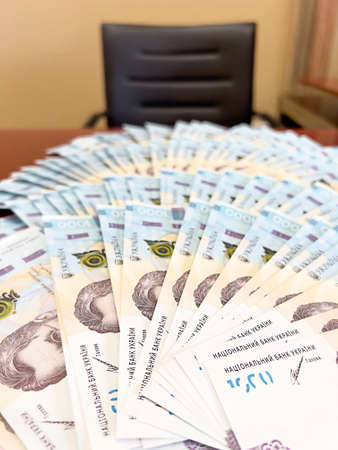The money of Ukraine is fanned out on the table.