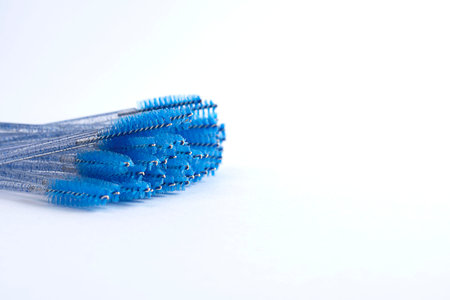 Professional cosmetology makeup brushes in blue on a white background. copy space. Close-up. Soft focus. Beauty concept.の写真素材