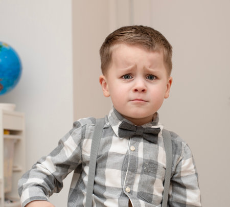 Emotions of sadness, resentment, sadness on the child s face. A small handsome boy of 4 years old in...