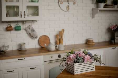 Kettle and saucepan on the kitchen table. kitchen appliances against a white kitchen backgroundの写真素材