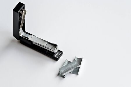 Stapler black with paper clips isolated on white background. Office accessoriesの写真素材