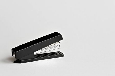 Stapler black with paper clips isolated on white background. Office accessoriesの写真素材
