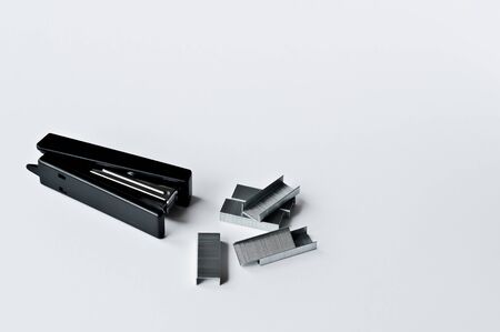 Stapler black with paper clips isolated on white background. Office accessories