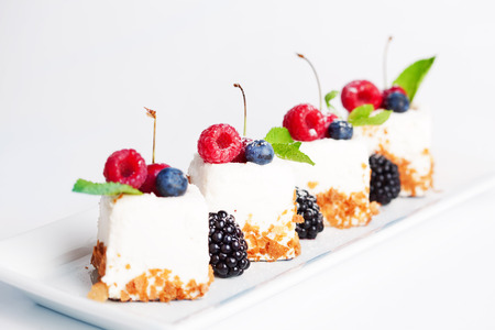 cakes with berries on a white background