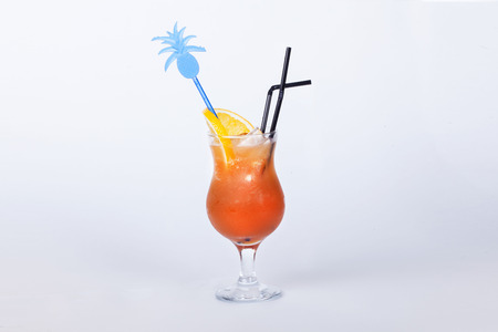  tropical cocktail with orange with a stick on a white backgroundの写真素材