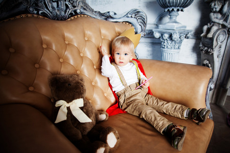 little boy prince with crown and sword in the castle happy childhood