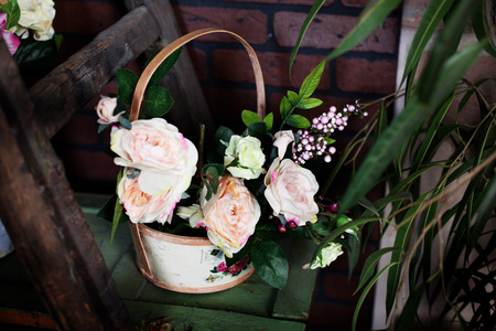 delightful basket with Silk flowers peonies on the shelfの写真素材