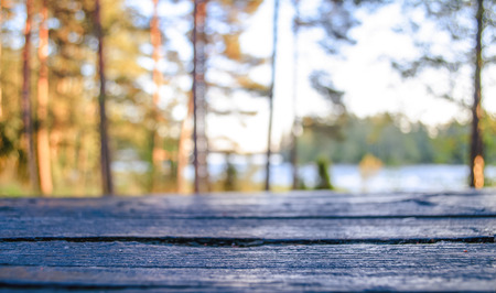 Autumn background. Template layout for product display. An empty wooden table on a blurred...