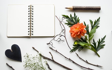 Creative layout of accessories, flowers and a notebook on a white background. A bright and stylish concept. View from above.の写真素材