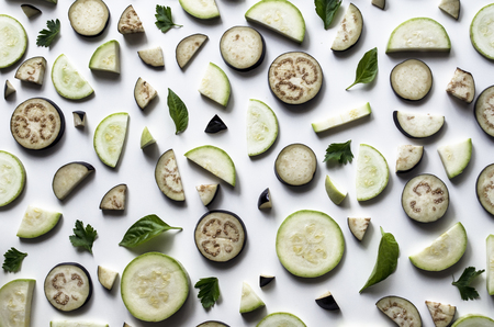 Fresh vegetables or vegetable background. Sliced  slices of eggplant and zucchini on a white background. Sample of food. Delicious texture. View from above.の写真素材