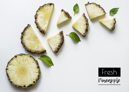 Creative layout of fresh sliced pineapple on a white background with space for text. Background of fruits. Isolated pineapple on a white background. View from aboveの写真素材