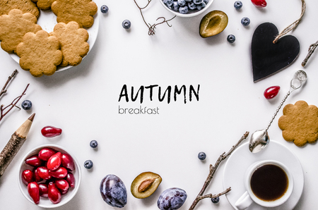 Breakfast. Autumn. Biscuits with coffee, fruit and berries on a white background. View from above.の写真素材