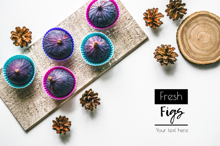 Figs. Food Photo. Fresh fruits and cones on a white background. Autumn composition with figs. View from above. Copy spaceの写真素材