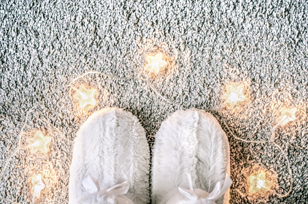 Home cozy Christmas composition with slippers on the carpet. Home decor and coziness.Top view. の写真素材