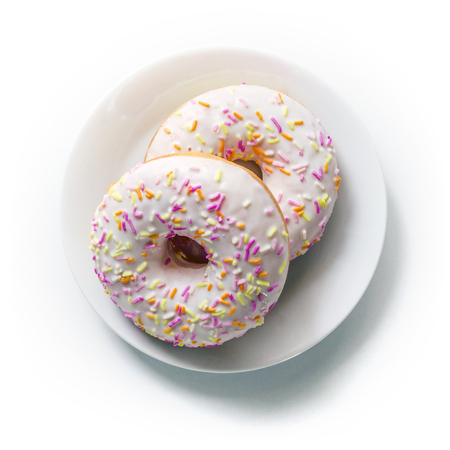 Donut on a plate and on a white background. Photo of sweets. Top view. Copy space. Mock-upの写真素材